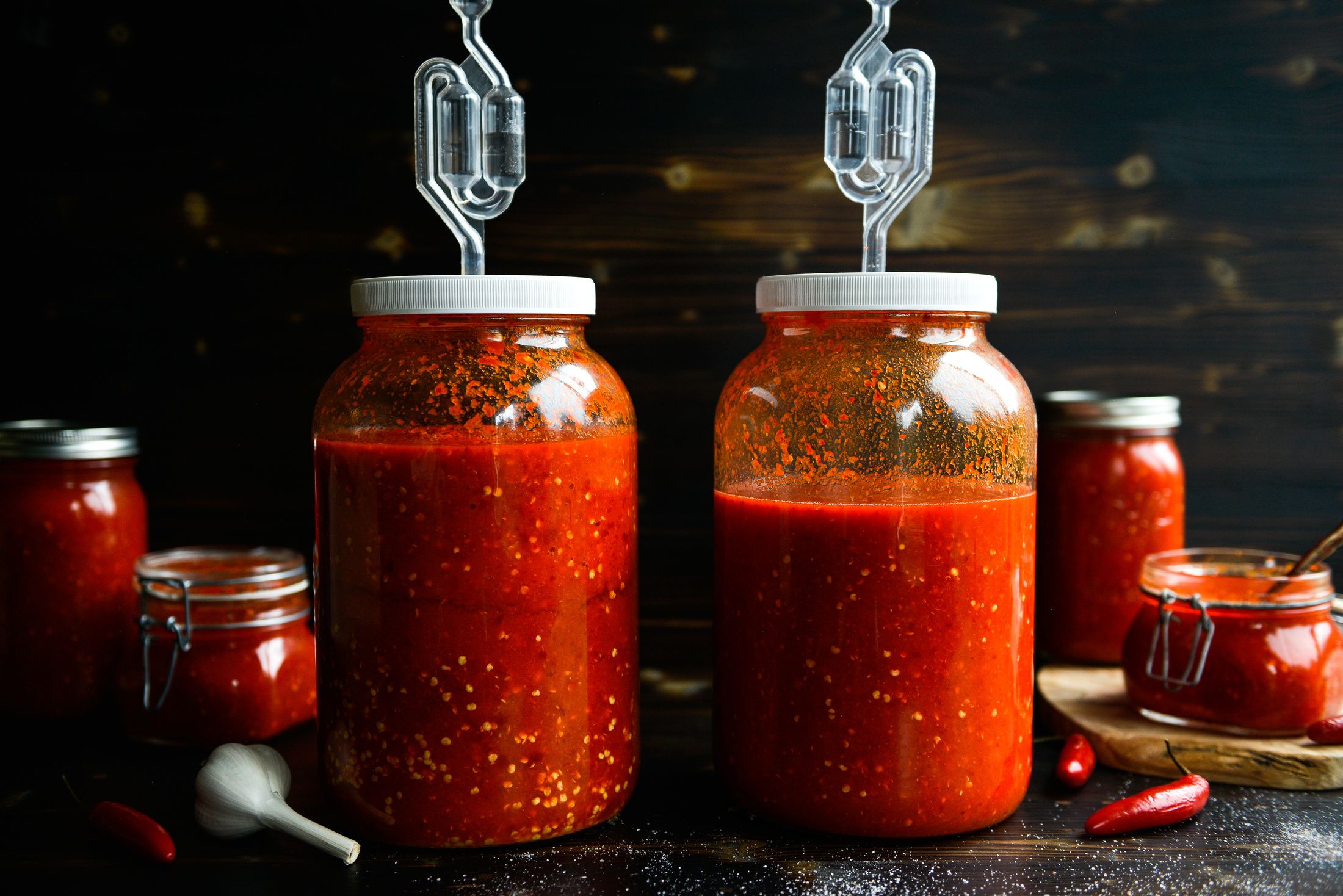 lacto-fermented hot sauce in jars with bubble airlocks